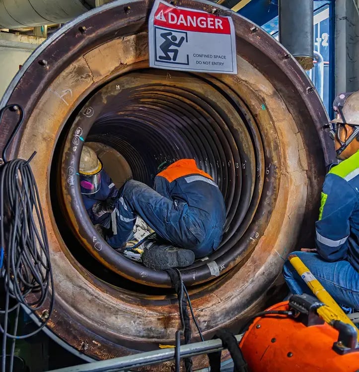 A worker investigating a displaced pipe