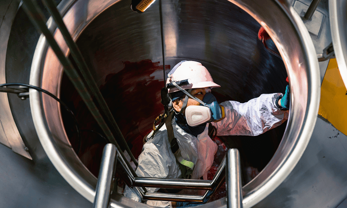 worker-entering-industrial-tank-confined-space-ppe